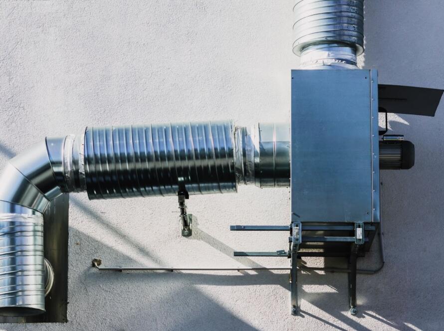 Heat recovery ventilator unit showing ventilation tubes and built-in fan mechanism